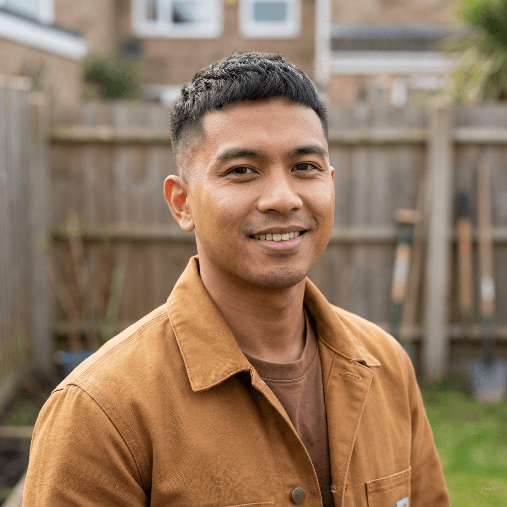 James Corrigan in a casual flannel shirt outdoors near a worksite